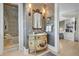 Elegant bathroom features a unique vanity, decorative wallpaper, and a glass enclosed shower at 212 Chinaberry Ln, Kiawah Island, SC 29455