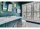 Elegant bathroom featuring marble countertops, sleek fixtures, shutters, and a modern toilet design at 212 Chinaberry Ln, Kiawah Island, SC 29455