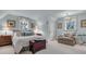 Serene bedroom featuring soft blue walls, chandelier, comfortable seating and lots of natural light at 212 Chinaberry Ln, Kiawah Island, SC 29455