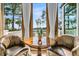 Cozy breakfast nook featuring a wooden table, leather chairs, and scenic outdoor views at 212 Chinaberry Ln, Kiawah Island, SC 29455