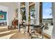 Breakfast nook with wooden table, leather chairs, and scenic views from floor to ceiling windows at 212 Chinaberry Ln, Kiawah Island, SC 29455