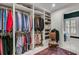 Spacious walk-in closet with custom shelving, organized hanging space, and an access to the ensuite bathroom at 212 Chinaberry Ln, Kiawah Island, SC 29455