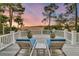 Relaxing deck featuring lounge chairs, potted plants, and scenic views of the surrounding landscape at 212 Chinaberry Ln, Kiawah Island, SC 29455