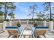 Deck area featuring lounge chairs and scenic views of the marsh and nature at 212 Chinaberry Ln, Kiawah Island, SC 29455