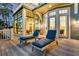 Relaxing deck features two chaise lounges with blue cushions and views into the interior through large windows at 212 Chinaberry Ln, Kiawah Island, SC 29455