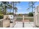 Outdoor deck area with a grill and views of the marsh at 212 Chinaberry Ln, Kiawah Island, SC 29455