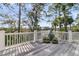 Spacious deck with potted plants and marsh views framed by trees in a relaxing outdoor space at 212 Chinaberry Ln, Kiawah Island, SC 29455