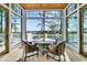 Bright dining area with great views, wood ceiling, and seating for four at 212 Chinaberry Ln, Kiawah Island, SC 29455