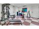 Basement exercise room featuring gym equipment, white walls, and checkered floor at 212 Chinaberry Ln, Kiawah Island, SC 29455
