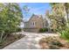 Well-maintained home exterior featuring a three-car garage, driveway, and manicured landscaping at 212 Chinaberry Ln, Kiawah Island, SC 29455