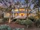 Charming two-story home with inviting front porch and mature trees in a beautiful landscaped yard at 212 Chinaberry Ln, Kiawah Island, SC 29455