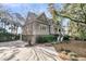 Beautifully landscaped exterior featuring a well-maintained lawn, mature trees, and a welcoming entrance at 212 Chinaberry Ln, Kiawah Island, SC 29455