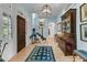 Elegant foyer with wood floors, staircase, and stylish decor at 212 Chinaberry Ln, Kiawah Island, SC 29455