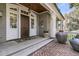 Charming front porch with wooden ceiling, brick floor, and stately planters flanking the entryway at 212 Chinaberry Ln, Kiawah Island, SC 29455