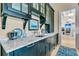 Kitchen counter area with black cabinets, marble countertop, sink, and stainless steel fixtures at 212 Chinaberry Ln, Kiawah Island, SC 29455