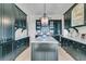 Stylish kitchen with dark cabinetry, marble countertops, a large island, and modern lighting at 212 Chinaberry Ln, Kiawah Island, SC 29455