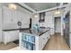 Bright kitchen with white cabinets, stainless steel appliances, and a functional kitchen island at 212 Chinaberry Ln, Kiawah Island, SC 29455