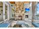 Inviting living room featuring stone fireplace, wood ceiling, TV, and comfortable seating at 212 Chinaberry Ln, Kiawah Island, SC 29455