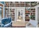 Living room with bookshelves from floor to ceiling and ladder at 212 Chinaberry Ln, Kiawah Island, SC 29455