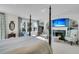 Luxurious main bedroom featuring a fireplace, TV, sitting area and views of the yard at 212 Chinaberry Ln, Kiawah Island, SC 29455