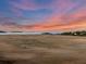 Marsh view with calm waters, blue sky, and a beautiful pink sunset background at 212 Chinaberry Ln, Kiawah Island, SC 29455