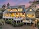 Beautiful rear exterior of home with covered decks, patios, and well-maintained landscaping at 212 Chinaberry Ln, Kiawah Island, SC 29455