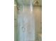 Modern shower stall with light teal, square tile, rainfall shower head and glass door at 212 Chinaberry Ln, Kiawah Island, SC 29455