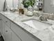 Close-up of vanity featuring a gray granite countertop, double sinks, and white cabinets at 218 Mohican Cir, Summerville, SC 29483