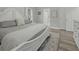 Bright bedroom featuring a decorative, distressed white bed frame and area rug at 218 Mohican Cir, Summerville, SC 29483