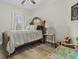 Bright bedroom with hardwood floors, ceiling fan, and decorative headboard at 218 Mohican Cir, Summerville, SC 29483