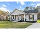 Charming single story home with a covered front porch and well maintained lawn and landscaping at 218 Mohican Cir, Summerville, SC 29483