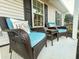 A close up of the cozy furniture and decor on the covered front porch of this lovely home at 218 Mohican Cir, Summerville, SC 29483