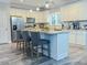 Kitchen with island seating, hardwood floors, granite countertops, and stainless steel appliances at 218 Mohican Cir, Summerville, SC 29483