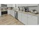 Kitchen with granite countertops, stainless steel appliances, white cabinets, and hardwood floors at 218 Mohican Cir, Summerville, SC 29483