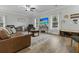 Bright living room with hardwood floors, neutral paint, ceiling fan and large windows at 218 Mohican Cir, Summerville, SC 29483