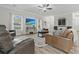 Living room with hardwood floors, ceiling fan, windows, television, and gray walls at 218 Mohican Cir, Summerville, SC 29483