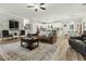 Open floor plan with living room and kitchen, hardwood floors and white kitchen cabinets at 218 Mohican Cir, Summerville, SC 29483