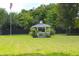 Scenic backyard featuring a gazebo, American flag and lush greenery at 219 Rigby St, Reevesville, SC 29471
