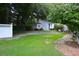 Charming backyard with a guest house, brick pathway, and well-maintained lawn and landscaping at 219 Rigby St, Reevesville, SC 29471