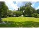 Large backyard showing home, out-building and American Flag at 219 Rigby St, Reevesville, SC 29471