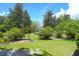 Picturesque yard with a decorative garden, brick border, and an American flag at 219 Rigby St, Reevesville, SC 29471