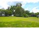 Large backyard showing home, out-building and American Flag at 219 Rigby St, Reevesville, SC 29471