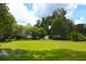 Spacious green backyard showing manicured lawn, auxiliary building and mature trees at 219 Rigby St, Reevesville, SC 29471