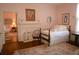 Comfortable bedroom featuring classic decor, hardwood floors, and soft natural light at 219 Rigby St, Reevesville, SC 29471