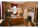 Bedroom featuring a four poster bed, brick fireplace and floral wallpaper at 219 Rigby St, Reevesville, SC 29471
