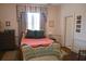 Bright bedroom featuring a queen bed, vintage couch, and large window for ample natural light at 219 Rigby St, Reevesville, SC 29471