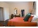 Cozy bedroom with warm colors and a large window with patterned drapes, complemented by an ornate mirror at 219 Rigby St, Reevesville, SC 29471