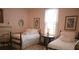 Cozy bedroom with two beds, traditional decor, and a warm, inviting atmosphere at 219 Rigby St, Reevesville, SC 29471