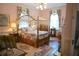 Bedroom featuring a canopy bed, a fireplace, and charming floral wallpaper at 219 Rigby St, Reevesville, SC 29471