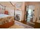 Charming bedroom with a four-poster bed, fireplace, and access to an adjacent room at 219 Rigby St, Reevesville, SC 29471
